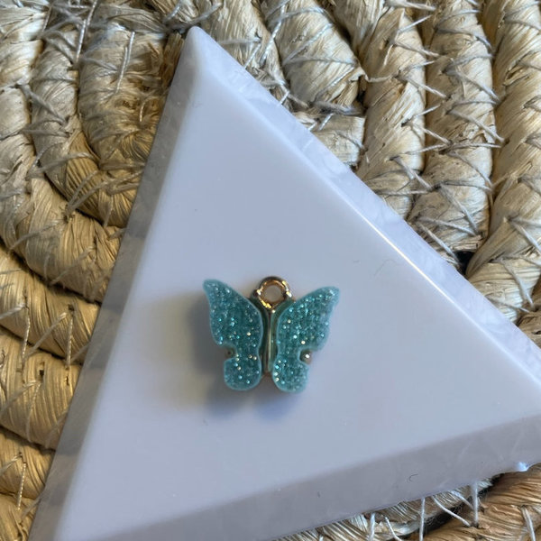 Bedel vlinder lichtblauw glitter - per stuk